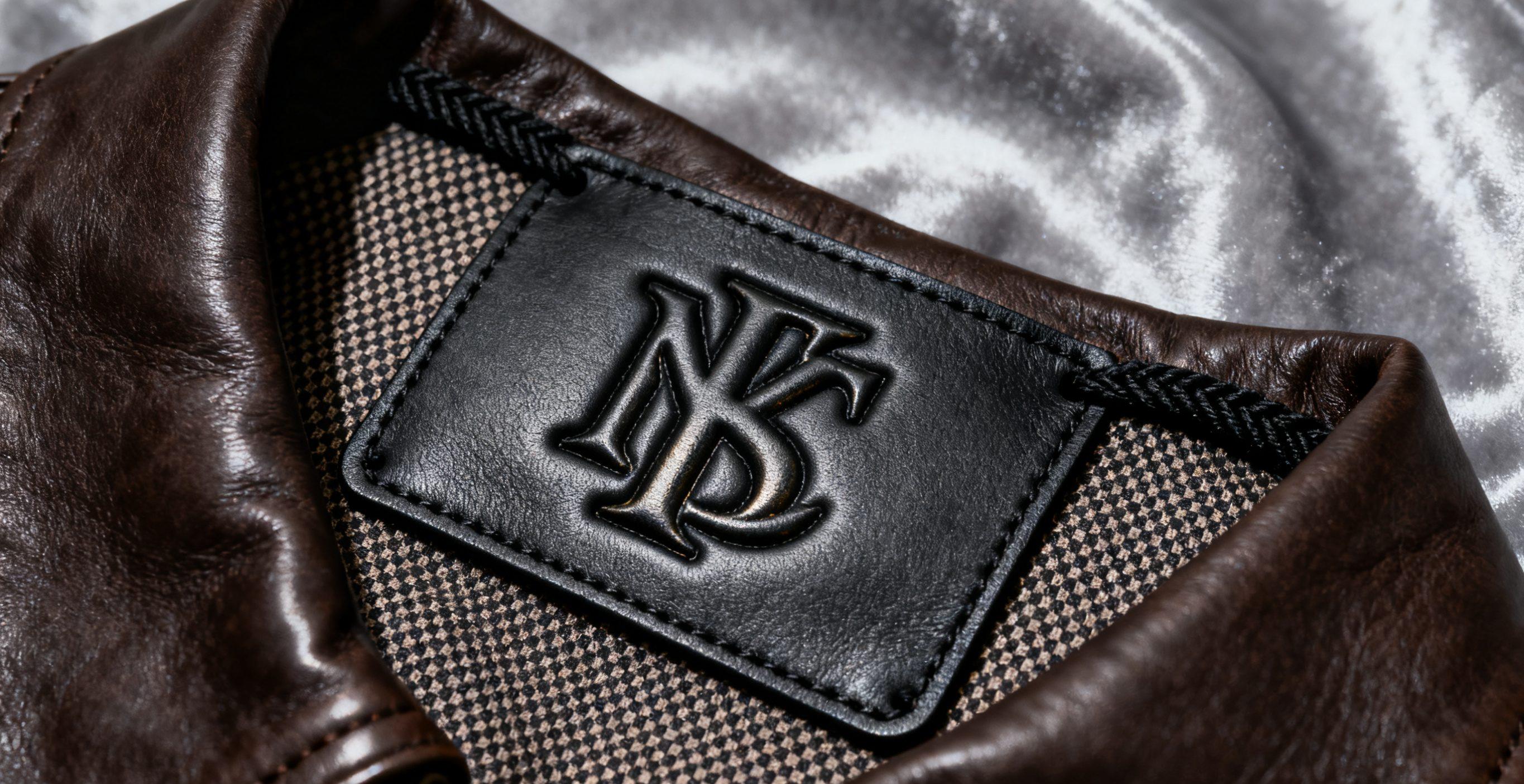 Embossed garment label with raised logo.